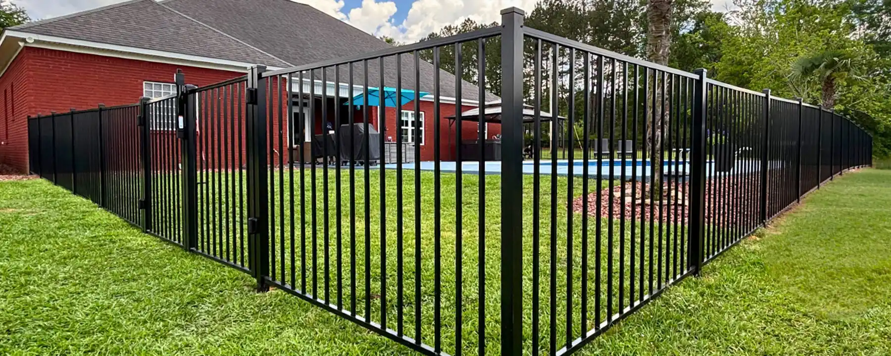 2-rail aluminum pool fence in a backyard in Mobile Alabama