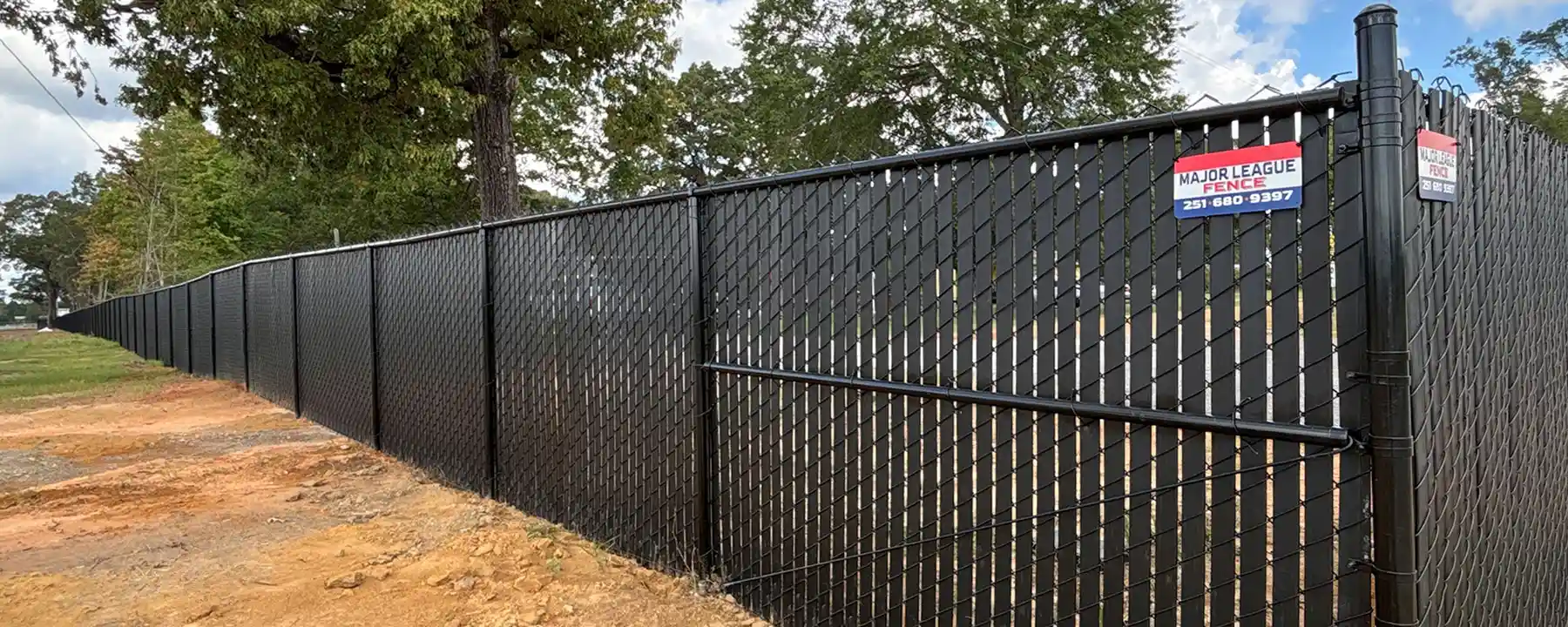 Black chain link commercial fence with privacy slats in Mobile Alabama