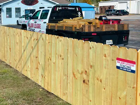 Company truck in front of wood fence installed by Major League Fence