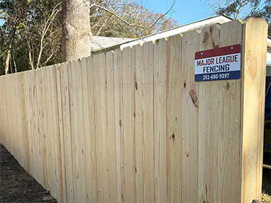 Stockade wood privacy fence with Major League Fence sign